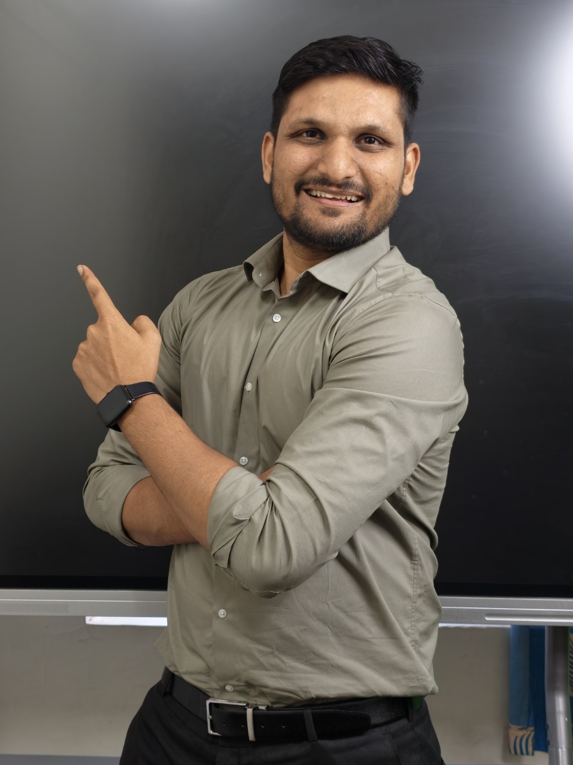Amol Kasar, founder of AKCA, pointing towards the classroom board